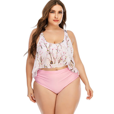 Fashionable plus-size floral print bikini top with pink high-waist bottom, showcased in a tropical setting with potted plants