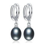 Elegant sterling silver dangle earrings featuring natural freshwater black pearls, perfect for adding a touch of sophistication to any outfit.