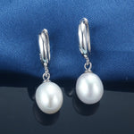 Elegant pearl drop earrings with 925 sterling silver settings, showcasing the natural beauty of freshwater pearls.