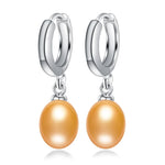 Elegant natural freshwater pearl dangle earrings with 925 sterling silver posts, showcasing a lustrous golden pearl accent.