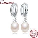 Elegant sterling silver pearl dangle earrings featuring natural freshwater pearls, showcased on a white background.