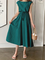 Elegant green cotton maxi dress with drawstring waist, vintage style short sleeves, and woven basket accessory in the product image.