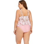 Floral print plus size swimsuit with ruffle top and solid pink bottoms, worn by a woman facing away from the camera.