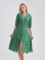 Elegant green cotton dress with eyelet details, featuring a v-neck, puff sleeves, a self-tie waist belt, and a flared, midi-length skirt. Ideal for a casual summer look.