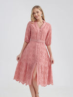 Stylish cotton summer dress with intricate eyelet embroidery, featuring a flirty mini hemline, v-neckline, and waist-cinching belt for a flattering silhouette. This pink, casual-chic dress from the laneberg brand captures the essence of warm-weather fashion.