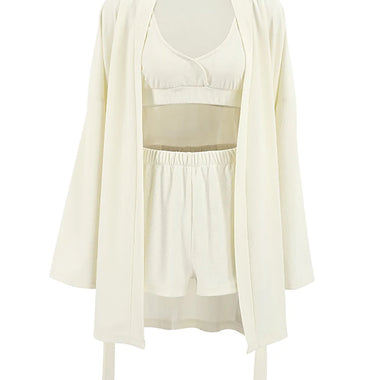 Elegant beige waffle shorts and blouse set by Laneberg. The soft, textured fabric creates a comfortable homewear look. The wide-leg shorts and sleeveless blouse with an open cardigan offer a stylish yet relaxed style.