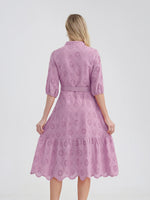 Lavender eyelet lace midi dress with calf-length ruffled hem, puff sleeves, and belted waist for a feminine, relaxed summer look.