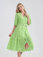 Beautiful lime green cotton dress with lace embroidered details, flared skirt, and belted waist for a chic summer look.