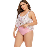 Floral print plus size women's swimsuit with ruffle top and high-waisted pink bottom, designed for beach or poolside fashion.