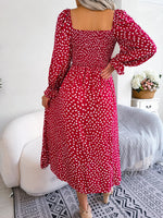 Casual ditsy floral print red maxi dress with puff sleeves, slim waist and ruched details, displayed on a white background.