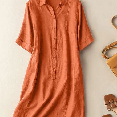 Elegant orange cotton sundress from laneberg brand, with button-down front and short sleeves, showcasing a vintage-inspired A-line silhouette.