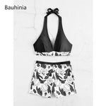 Elegant black and white floral print halter bikini with high-waist shorts from the Bauhinia swimwear collection.