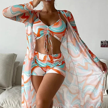 Stylish swimsuit set with abstract print. Tankini style top and matching shorts, perfect for beach and pool wear. Vibrant colors and modern design create a trendy, fashion-forward look.