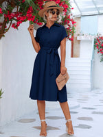 Elegant summer dress with bougainvillea, straw hat, and retro sunglasses - stylish woman's fashion for a warm weather vacation.