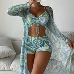 Vibrant print swimwear set, two-piece tankini with patterned wrap, stylish beachwear for women.