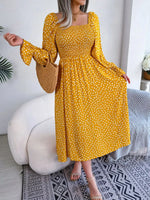 Casual floral print maxi dress with puff sleeves and ruched waist, displayed on a woman standing in front of a neutral background.