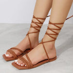 Open toe lace-up flat sandals in a warm brown color from laneberg women's fashion brand, suitable for summer beach or casual wear.