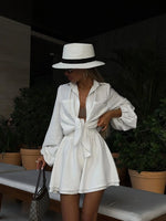 Elegant white summer outfit, chic white hat and blouse, stylish playsuit, fashionable accessories, luxurious laneberg design, ideal for warm casual outings.