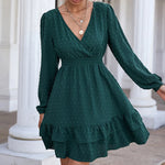 Elegant green polka dot dress with long puffy sleeves, frilly hemline, and a V-neck neckline from the laneberg fashion brand.