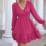 Elegant pink chiffon fashion dress with v-neck, waist ruffle, and long balloon sleeves, featured on a model in a minimalist indoor setting.