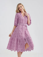 Elegant lavender eyelet cotton dress with belted waist and tiered skirt, perfect for warm weather occasions.